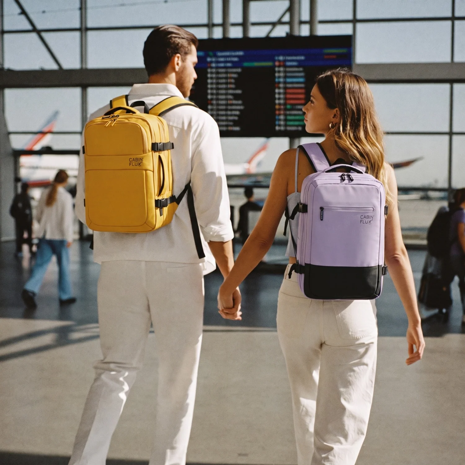 Couple with Iconic cabin backpacks at the airport