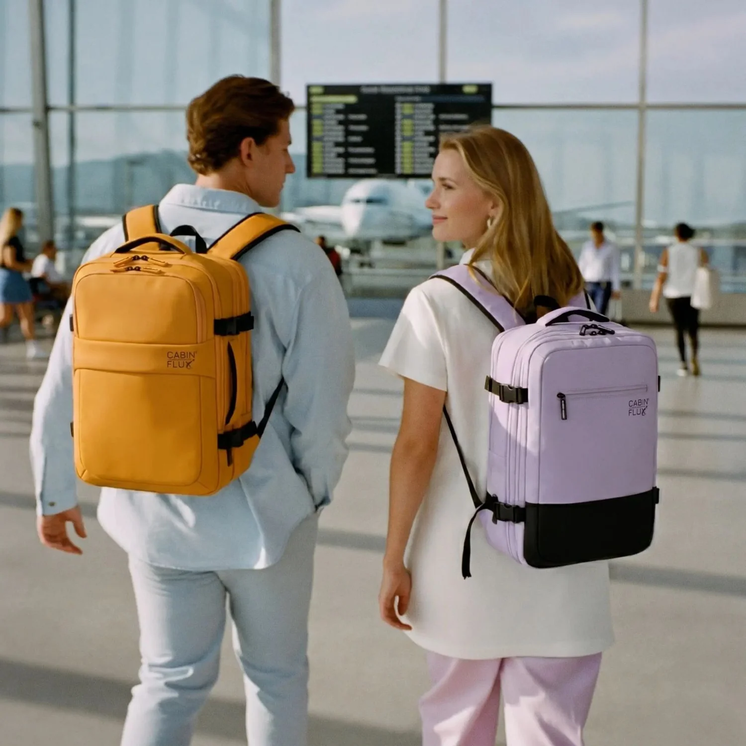 Couple with Iconic pastel cabin backpacks at the airport